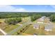 An aerial shot featuring houses lining a road, surrounded by lush wooded areas and farmland at 41 Liam Dr, Broadway, NC 27505