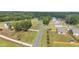 An aerial view shows the neighborhood with new construction homes surrounded by lush greenery and a winding road at 41 Liam Dr, Broadway, NC 27505
