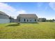Spacious backyard features lush lawn, trampoline, and gray siding, offering plenty of room for outdoor activities and relaxation at 41 Liam Dr, Broadway, NC 27505
