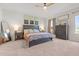 Calming main bedroom features a ceiling fan, a king bed, and bedside lamps at 41 Liam Dr, Broadway, NC 27505