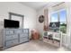 Cozy bedroom features neutral carpet, gray dresser with mirror, and large window at 41 Liam Dr, Broadway, NC 27505