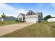 Well-maintained home with a spacious driveway, attached garage, and attractive landscaping, offering a welcoming curb appeal at 41 Liam Dr, Broadway, NC 27505