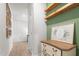 Hallway featuring fresh paint, decorative trim, a chest, and floating shelves at 41 Liam Dr, Broadway, NC 27505