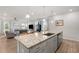 Open-concept kitchen with granite counters, stainless steel appliances, flowing into the cozy living room at 41 Liam Dr, Broadway, NC 27505