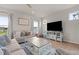 Well-lit living room offering comfortable sofas, large television, and a ceiling fan at 41 Liam Dr, Broadway, NC 27505