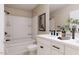 Well-lit bathroom showcasing a tub-shower combo, double sink vanity with modern fixtures, and stylish decorative accents at 426 Rowe Way, Knightdale, NC 27545