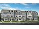 A row of beautifully constructed townhomes with varied neutral color palettes and manicured landscaping at 426 Rowe Way, Knightdale, NC 27545