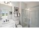Well-lit bathroom featuring a walk-in shower, modern fixtures, and clean white cabinetry at 430 Rowe Way, Knightdale, NC 27545