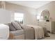 Cozy bedroom featuring a large window, dresser with a round mirror, and a comfortable bed with decorative pillows at 430 Rowe Way, Knightdale, NC 27545