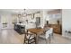 Spacious kitchen flowing into dining area, featuring stainless steel appliances and a large island at 430 Rowe Way, Knightdale, NC 27545