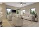 Bright living room with a ceiling fan, neutral paint, large windows, and comfortable seating arrangements at 430 Rowe Way, Knightdale, NC 27545
