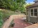 Charming brick patio with retaining wall, creating a cozy outdoor space at 6008 Chittim Ct, Raleigh, NC 27616