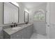 Elegant bathroom with granite countertop, double sinks, decorative mirrors, and a garden window at 6008 Chittim Ct, Raleigh, NC 27616