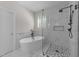 Bright bathroom featuring a new tub, shower, and white marble tile at 6008 Chittim Ct, Raleigh, NC 27616