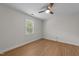 Clean bedroom with laminate wood flooring, a ceiling fan, and a window with bright natural light at 6008 Chittim Ct, Raleigh, NC 27616