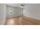 Light-filled bedroom features hard wood floors, a ceiling fan, and two windows for optimal natural light at 6008 Chittim Ct, Raleigh, NC 27616