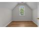 Bedroom with hardwood floors and natural light from a large window at 6008 Chittim Ct, Raleigh, NC 27616