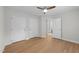 Bright bedroom featuring wood floors, a ceiling fan, and an ensuite bathroom for convenience at 6008 Chittim Ct, Raleigh, NC 27616
