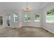 Bright dining area with a modern light fixture, lots of natural light, and views of the backyard at 6008 Chittim Ct, Raleigh, NC 27616