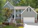 Charming two-story home features a two-car garage, manicured landscaping, and inviting entryway with brick accents at 6008 Chittim Ct, Raleigh, NC 27616