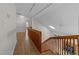 Bright hallway with wood floors leads to the split-level stairs and a view of the home's entry at 6008 Chittim Ct, Raleigh, NC 27616