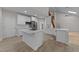 Modern kitchen with white cabinets, stainless steel appliances, an island, and sleek countertops at 6008 Chittim Ct, Raleigh, NC 27616