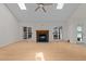 Spacious living room with hardwood floors, fireplace, and abundant natural light through skylights and glass doors at 6008 Chittim Ct, Raleigh, NC 27616