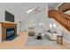 Inviting living room with fireplace, hardwood floors, and skylights, offering ample natural light and a cozy atmosphere at 6008 Chittim Ct, Raleigh, NC 27616