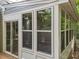 Detailed view of the sunroom's multiple windows and back deck access at 6008 Chittim Ct, Raleigh, NC 27616