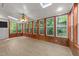 Well-lit sunroom with multiple windows and a ceiling fan at 6008 Chittim Ct, Raleigh, NC 27616