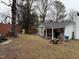 Spacious backyard featuring a patio, lawn equipment, and mature trees at 6908 Park Pl, Raleigh, NC 27616