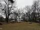 Spacious backyard with trees, trailer, boat, and playset, offering ample space for outdoor activities at 6908 Park Pl, Raleigh, NC 27616