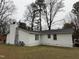 Rear exterior of home featuring a spacious backyard and mature trees at 6908 Park Pl, Raleigh, NC 27616