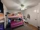 Bedroom with a bunk bed, ceiling fan, and plenty of toys at 6908 Park Pl, Raleigh, NC 27616
