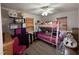 Bedroom with a bunk bed, shelves, a desk and toys galore at 6908 Park Pl, Raleigh, NC 27616