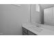 Bathroom featuring a single sink with gray cabinets, a large mirror, and white trim at 701 Jamescroft Way, Rolesville, NC 27571