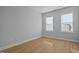 Bedroom featuring wood floors, and two large windows at 701 Jamescroft Way, Rolesville, NC 27571