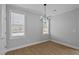 Formal dining room with modern chandelier, two windows, and light gray walls at 701 Jamescroft Way, Rolesville, NC 27571