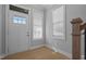 Bright foyer with wood-look floors, white door with sidelight, and natural light from windows at 701 Jamescroft Way, Rolesville, NC 27571