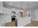 Bright, modern kitchen with white cabinetry, stainless steel appliances, and large center island at 701 Jamescroft Way, Rolesville, NC 27571
