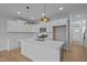 Bright, modern kitchen with white cabinetry, stainless steel appliances, and large center island at 701 Jamescroft Way, Rolesville, NC 27571