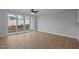 Bright living area with sliding glass doors to backyard, ceiling fan, and wood-look flooring at 701 Jamescroft Way, Rolesville, NC 27571