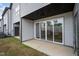 Back patio featuring a sliding glass door and a small patch of grass at 701 Jamescroft Way, Rolesville, NC 27571
