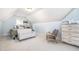 Cozy attic featuring a daybed, a chair, and dresser, under the pitched roof with a small window at 7336 Capulin Crest Dr, Apex, NC 27539