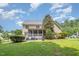 Beautiful backyard featuring lush green grass, mature trees, and a screened-in porch at 7336 Capulin Crest Dr, Apex, NC 27539
