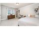 Bright bedroom featuring a wooden dresser, a built in bookshelf, and a bed with neutral bedding at 7336 Capulin Crest Dr, Apex, NC 27539
