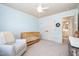 Cozy Bedroom with a white rocking chair, a wooden crib, and a view to the ensuite bathroom at 7336 Capulin Crest Dr, Apex, NC 27539
