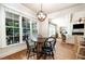 Bright dining area with wood table and chairs, large windows overlooking the backyard at 7336 Capulin Crest Dr, Apex, NC 27539