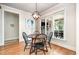 Cozy dining area features a decorative lighting fixture with backyard views from the window at 7336 Capulin Crest Dr, Apex, NC 27539