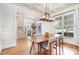 Elegant dining room with coffered ceiling, modern light fixture, and large windows at 7336 Capulin Crest Dr, Apex, NC 27539